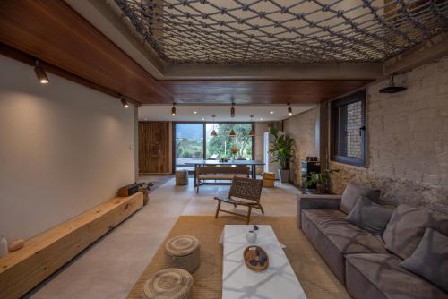 a living room with a couch and a table at Yangshuo Hillside Homestay in Yangshuo