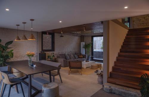 a living room with a table and a staircase at Yangshuo Hillside Homestay in Yangshuo