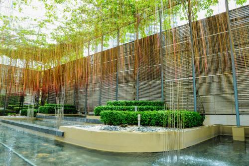 a building with a fence and some bushes and trees at Wedgewood Residences in Kuala Lumpur