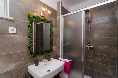 a bathroom with a sink and a shower at Apartment & Room Lady O in Dubrovnik