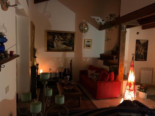 a living room with a red couch and a christmas tree at Lisa's home Piedimonte Etneo in Piedimonte Etneo