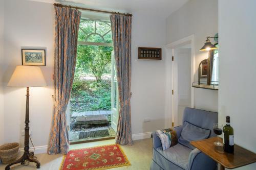 a living room with a blue couch and a window at The Nook at Henge Estate in Salisbury