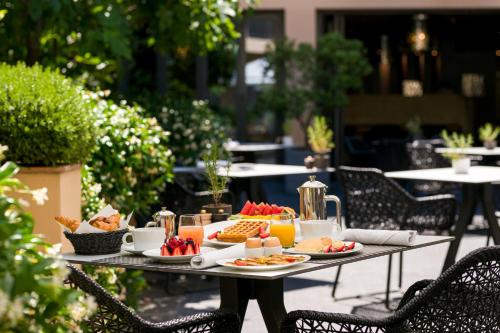a table with a tray of food on it at Hôtel de Paris Saint-Tropez in Saint-Tropez