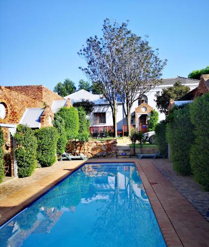 a swimming pool in the yard of a house at Van Dykshuis Guest House in Heidelberg