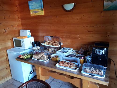 a table with food on top of it with a refrigerator at B&B La Seigneurie in Les Gets