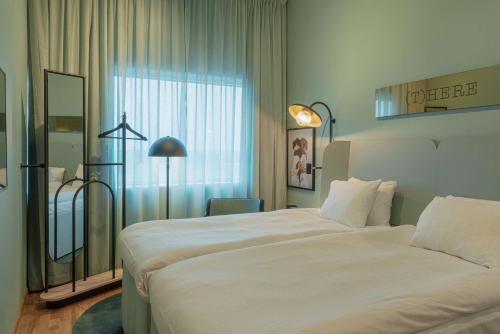 a hotel room with a large bed and a window at Scandic Landvetter in Landvetter