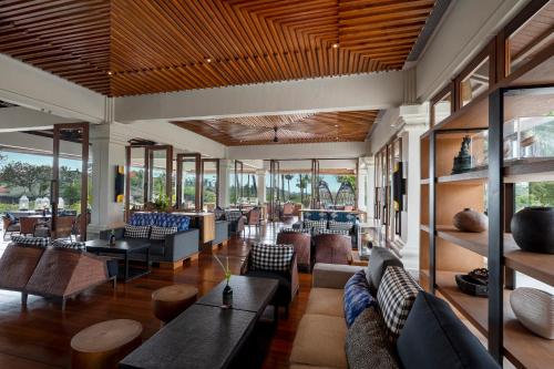 a lobby of a hotel with couches and tables at Grand Hyatt Bali in Nusa Dua