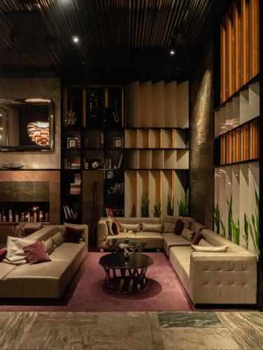 a living room with couches and a table at 11 Mirrors Design Hotel in Kyiv