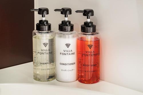 a group of four bottles sitting on a shelf at Hotel Village Izukogen in Ito