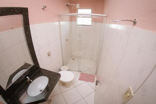 a bathroom with a shower and a toilet and a sink at Hotel Eldorado de Salinas in Salinas