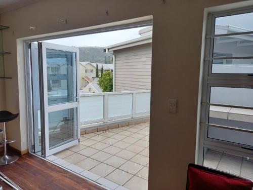 a view of a balcony with a sliding glass door at Friendz Self Catering Guesthouse in Knysna