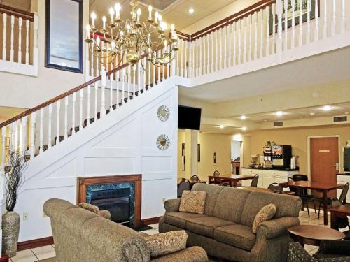 a living room with couches and a staircase at Quality Inn & Suites Bellville - Mansfield in Bellville