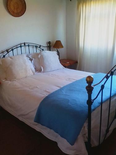a bedroom with a large bed with a baby laying on it at Bateleur Nature Reserve in Modimolle