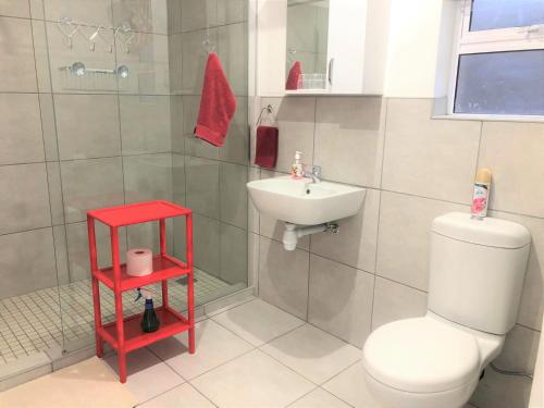 a bathroom with a white toilet and a sink at Baylight Accommodation 3 Selfcatering 1 bedroom apartment sleeps 4 in Mossel Bay