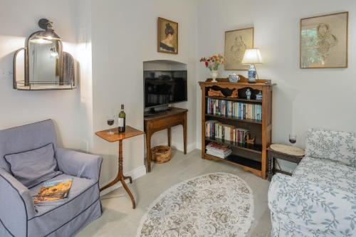 a living room with a couch and a chair at The Nook at Henge Estate in Salisbury