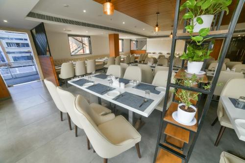 a dining room with a long table and chairs at Northway Hotel in Visakhapatnam