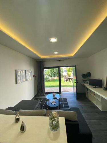 a living room with a couch and a table at Garden Apartment Dona Amélia in Abrantes