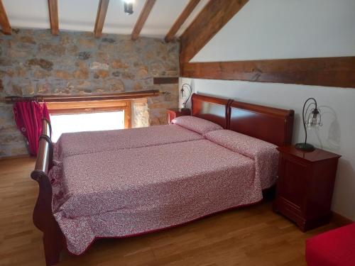 a bedroom with a bed and a window at Errotazar apartamento rural I in Alsasua