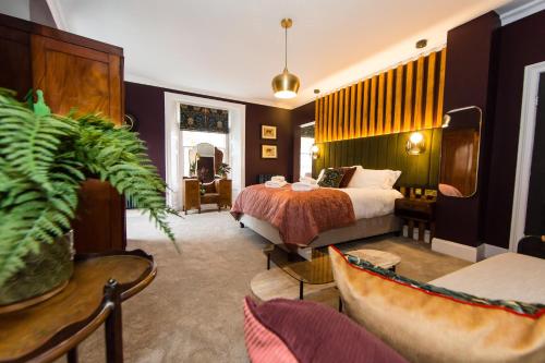 a hotel room with a bed and a couch at Skeldale House 'All Creatures Great & Small' Luxury Apartments & Studios in Askrigg, Yorkshire Dales in Askrigg