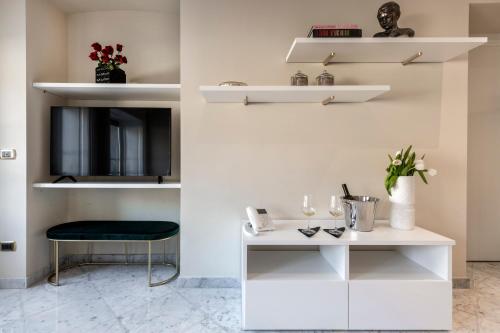 a room with white shelves and a table and a stool at Imperiale Suites Milano in Milan