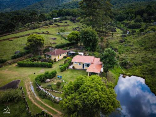 an aerial view of a house on a hill at Fazenda Monte Verde A Morada do Muriqui in São Francisco Xavier