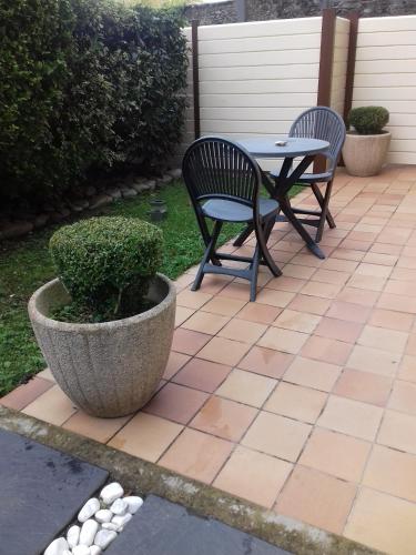 two chairs and a table on a patio at Mahe in Plancoët