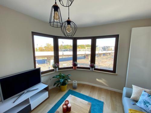 a living room with a large window and a flat screen tv at Appartements Gustav in Brussels