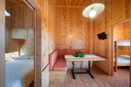 a room with two beds and a table in a room at Casa Rododendro in Barzio