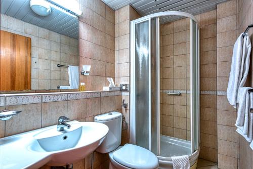 a bathroom with a toilet and a sink and a shower at Hotel Splendido in Kotor