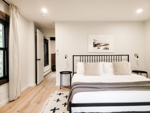 a bedroom with a large bed and a window at Black Pearl Unit 1 - Lake Placid, Mirror Lake in Lake Placid