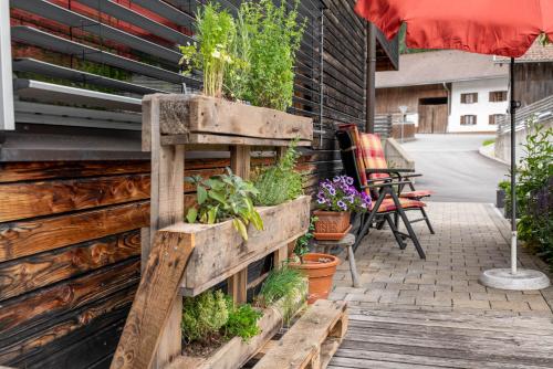 a wooden planter with plants in it on a patio at Ferienwohnung Heidi in Elmen