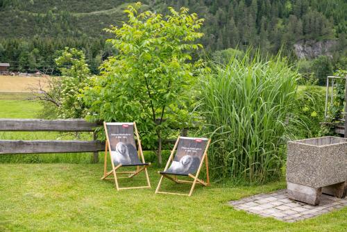 two chairs sitting in the grass in a yard at Ferienwohnung Heidi in Elmen