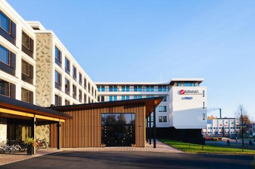 a building in front of a building at Original Sokos Hotel Kimmel Joensuu in Joensuu