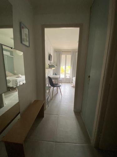 a hallway leading to a living room with a table at Hotel Carina in Apt