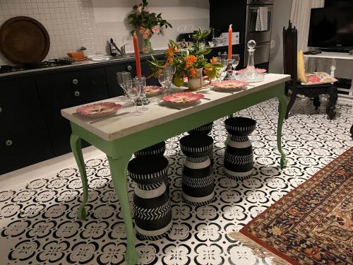 a table with plates and glasses on it in a kitchen at TREETOPS PENTHOUSE Rose Bay Sydney, 3 bedrooms in Sydney