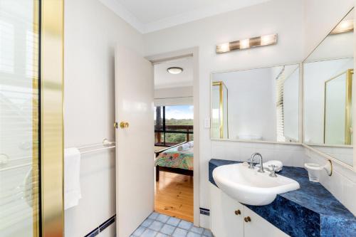 a bathroom with a sink and a mirror at Red Door - Enjoy Exclusive Front Row Sunsets from the Balcony & Walks to the Surf in Gnarabup in Gnarabup