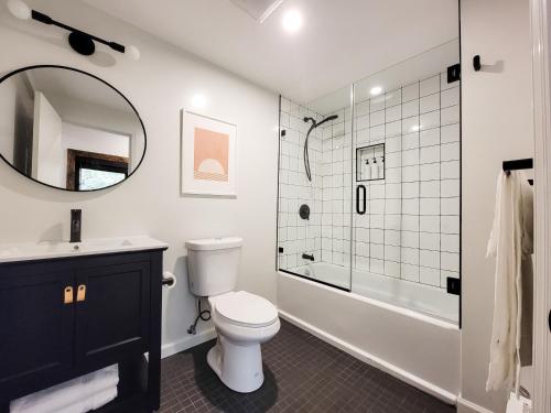 a bathroom with a toilet and a sink and a shower at Black Pearl Unit 2 - Lake Placid, Mirror Lake in Lake Placid