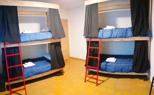 two bunk beds in a room with blue beds at OliWine hostel in Maipú