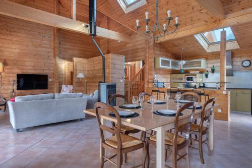 une salle à manger et un salon avec une table et des chaises dans l'établissement Séjour cosy, maison en bois pour 8, à Sarzeau