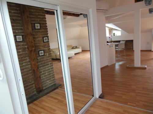 a sliding glass door in a room with a brick wall at Florence Studio in Varna City