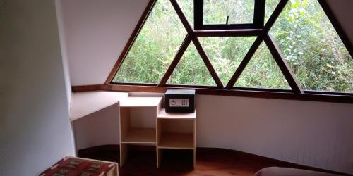 a small room with a large window with a scale at Cuyinco Domos in Riñinahue