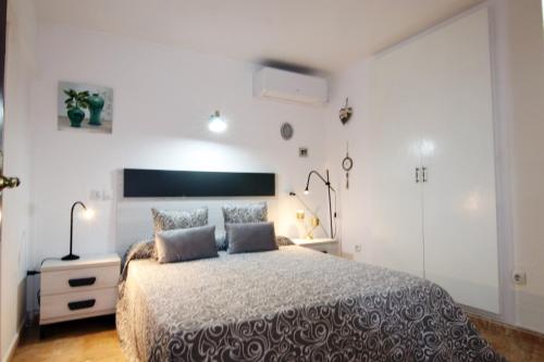 a bedroom with a large bed with two pillows at Apartment with balcony close to the beach in Lloret de Mar