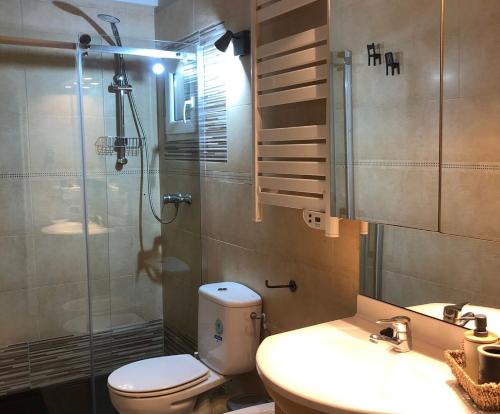 a bathroom with a shower and a toilet and a sink at Apartment with balcony close to the beach in Lloret de Mar