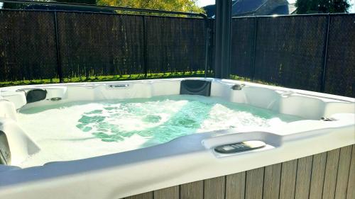 a jacuzzi tub with water in a backyard at Cottage du Lac Studio in Nivezé