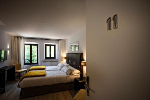 a bedroom with a bed and a door open at Hotel Pura Vida in Valgañón