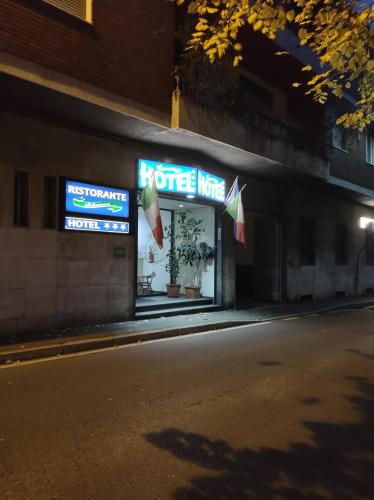 a store on the side of a street at night at Hotel Marinoni in Lomazzo
