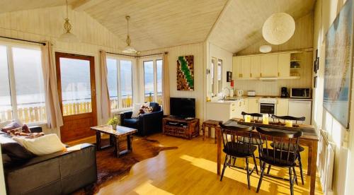 a living room with a couch and a table at Langahlid Cottages & Hot Tubs in Seyðisfjörður