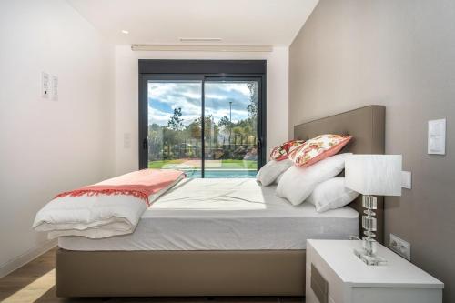 a bedroom with a large bed with a window at Colinas in Orihuela Costa