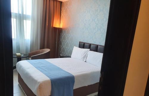 a hotel room with a bed and a window at Costa Del Sol Hotel by Arabian Link in Kuwait