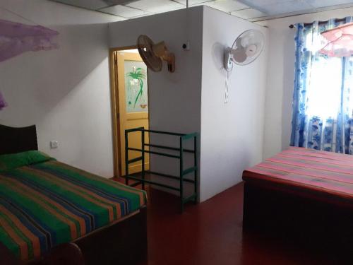 a bedroom with a bed and a door with a window at Fort Sea View Hotel in Matara